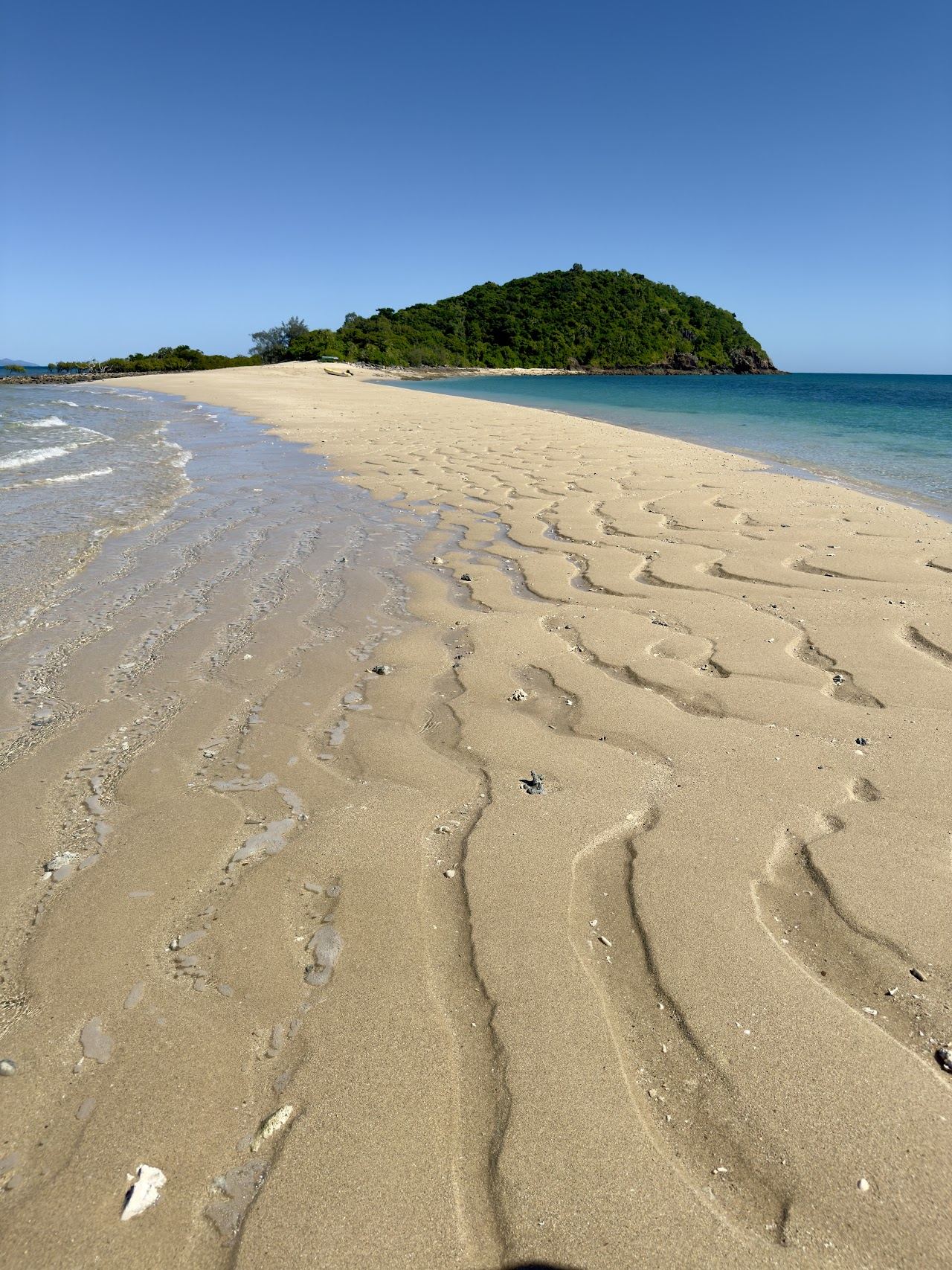 Long white sand spit reaching into turquoise water off Langford Island in the Whitsundays