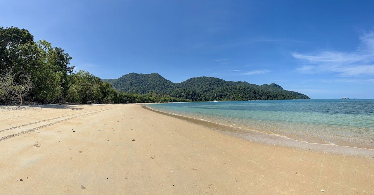 White sand crescent where rainforest meets the clear Andaman Sea at Datai Bay in Langkawi