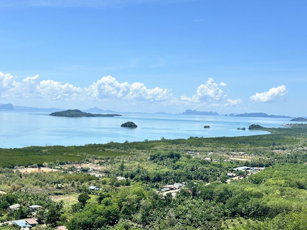 Green headland and quiet water at the secluded Nui Beach cove in the south of Koh Lanta