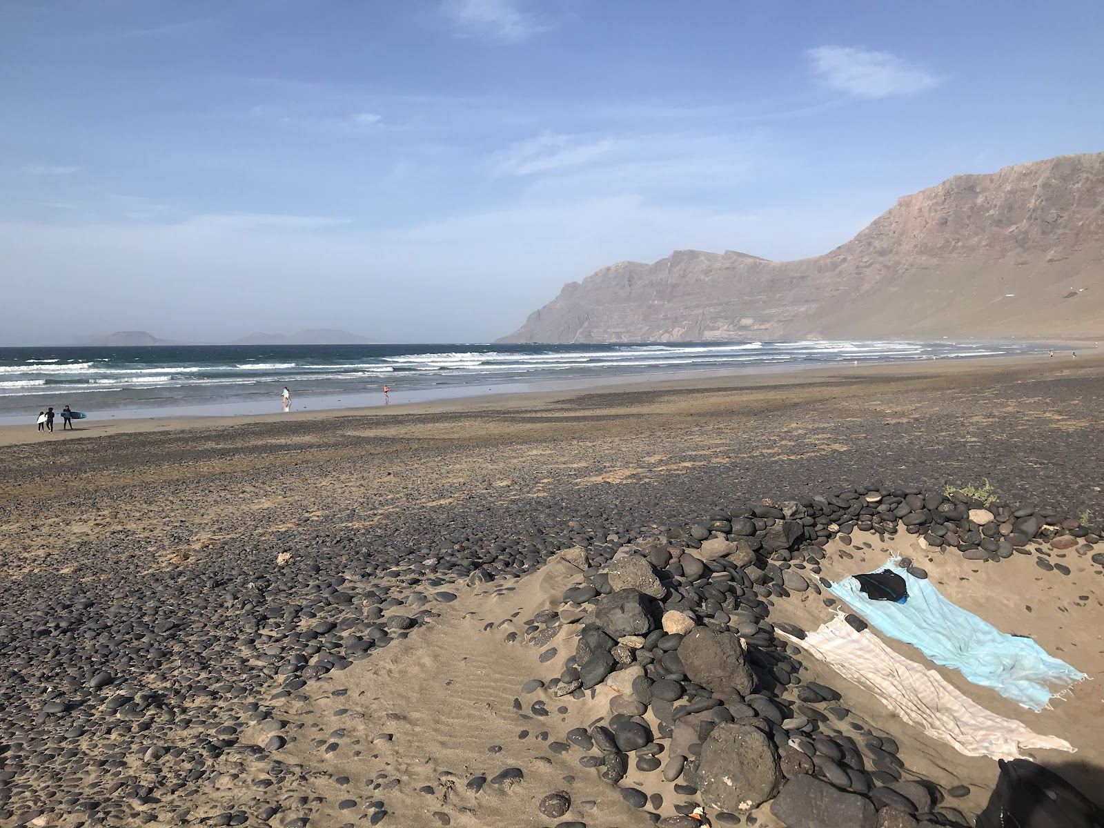 Wide golden sand and surf under the cliffs at Playa de Famara, Lanzarote
