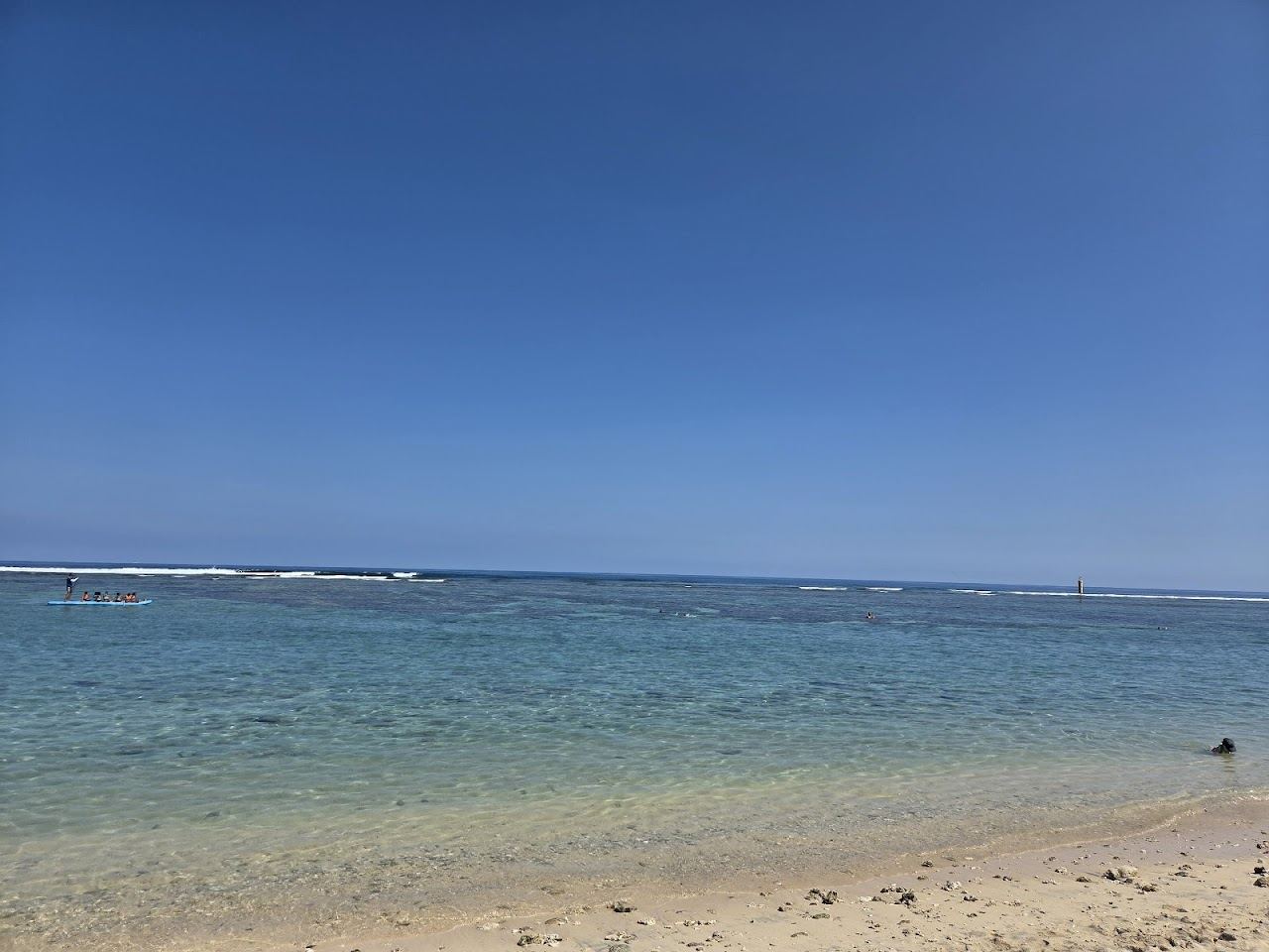 The calm turquoise reef lagoon and white sand under filao pines at L'Hermitage beach near Saint Gilles in Reunion