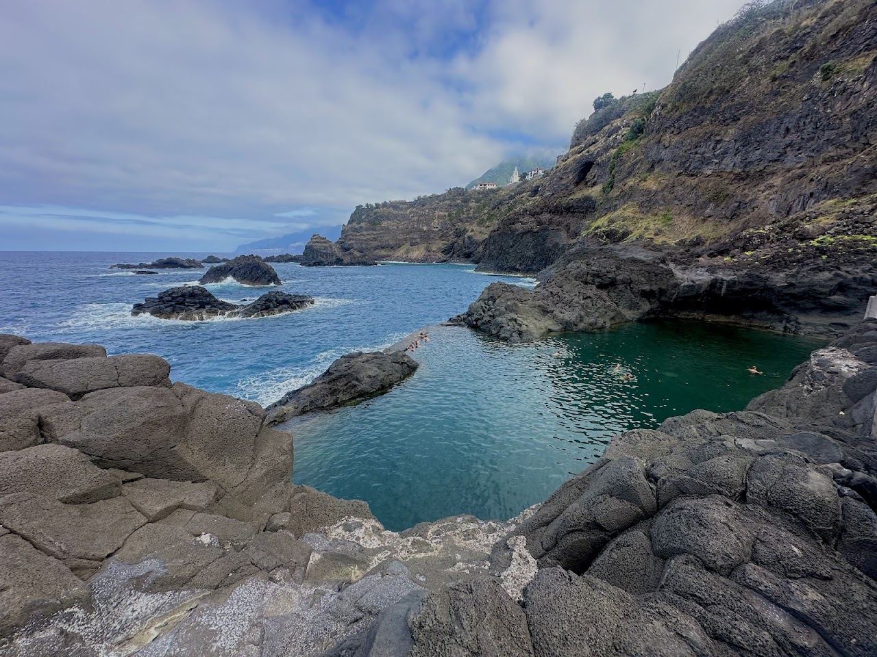 The rocky Atlantic shoreline and promenade below the Lido quarter of Funchal