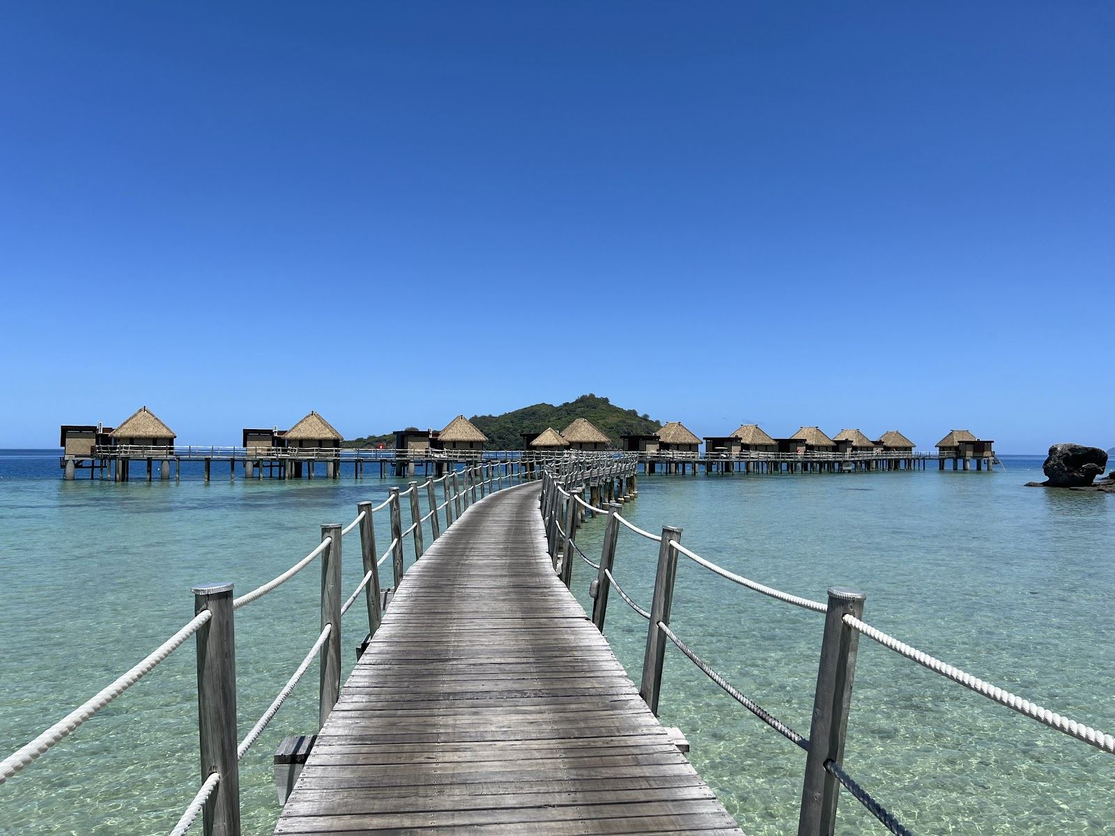 Calm clear lagoon water and soft white sand at Liku Beach by Likuliku Lagoon on Malolo Island in Fiji