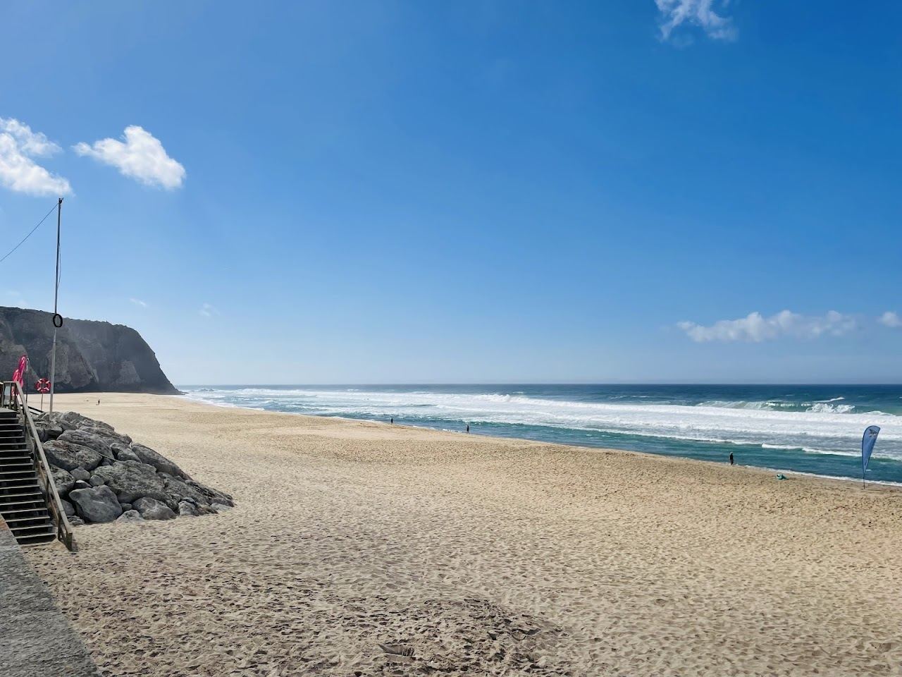 The wide cliff backed sand and surf of Praia Grande on the Sintra coast
