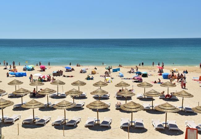 The wide sand and fort of Praia de Carcavelos on the Lisbon coast