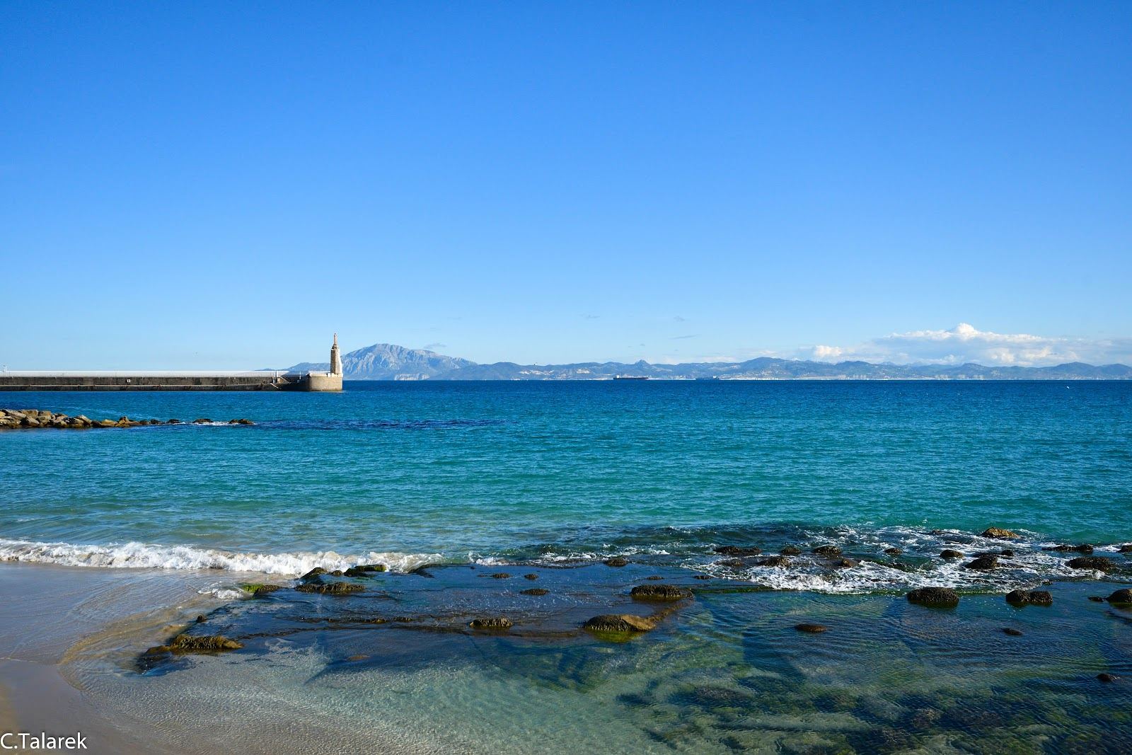 Wide pale sand and kitesurfers on the wind swept Los Lances beach at Tarifa on the Costa de la Luz