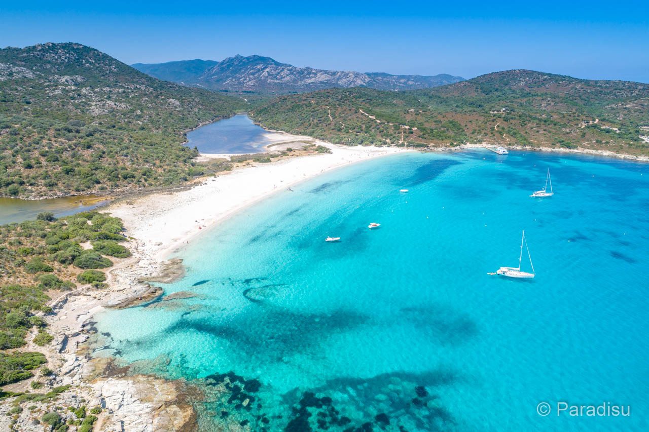 Soft white sand and shallow turquoise water at the wild Lotu beach in the Agriates near Saint Florent in Corsica