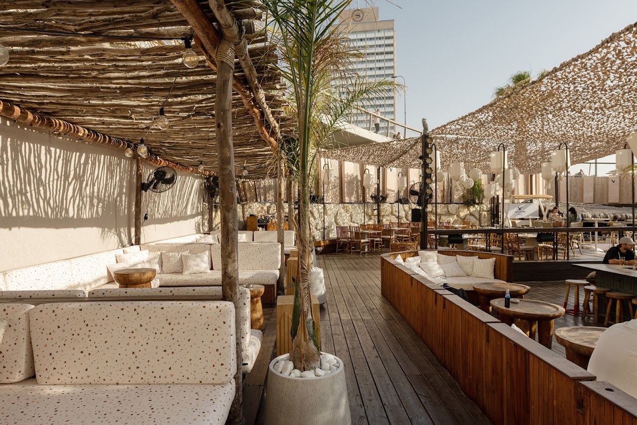 The raised wooden deck of Loullie facing the sea above Gordon beach on the Tel Aviv promenade