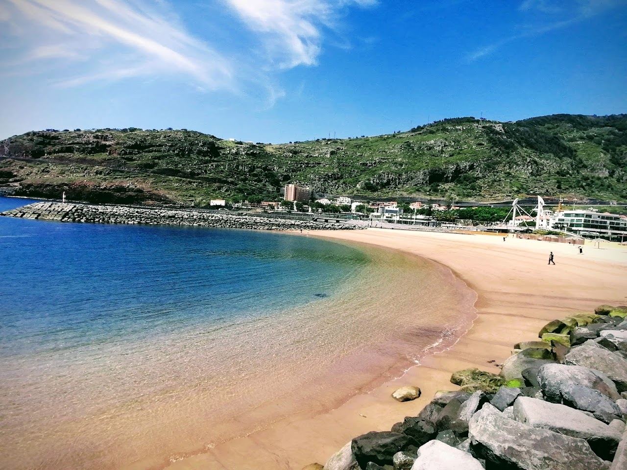 Golden imported sand and calm sheltered water between two piers at Machico on the east coast of Madeira