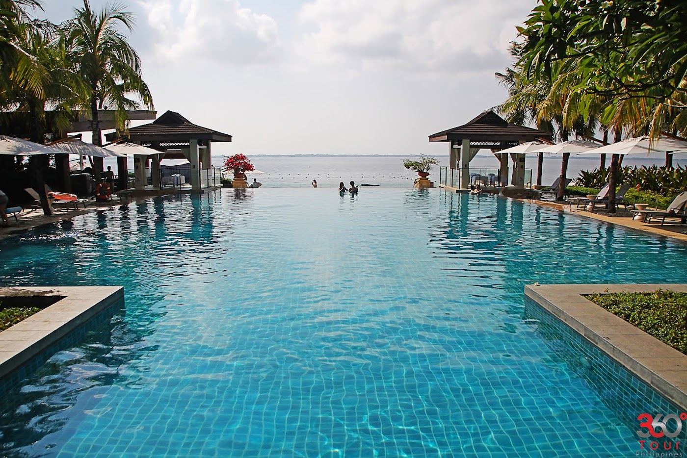 Quiet polished resort cove and calm water at golden hour suited to couples on Mactan Island in Cebu Philippines
