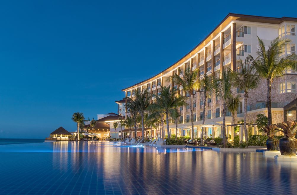 Evening light over a resort beach and calm channel water on Mactan island near Cebu