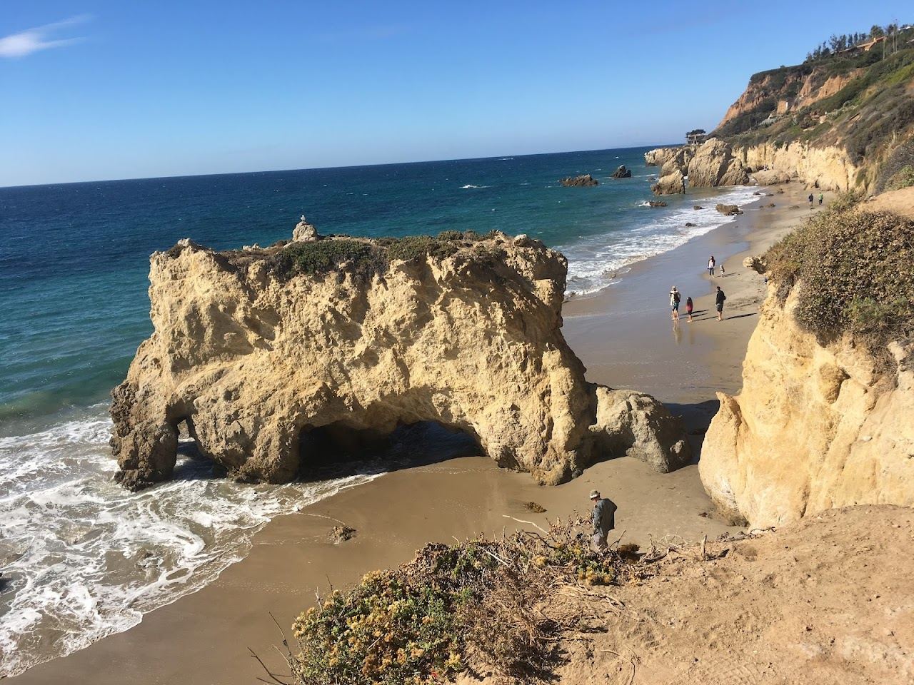 Sea stacks and arch silhouetted against the Pacific sunset at El Matador State Beach in Malibu
