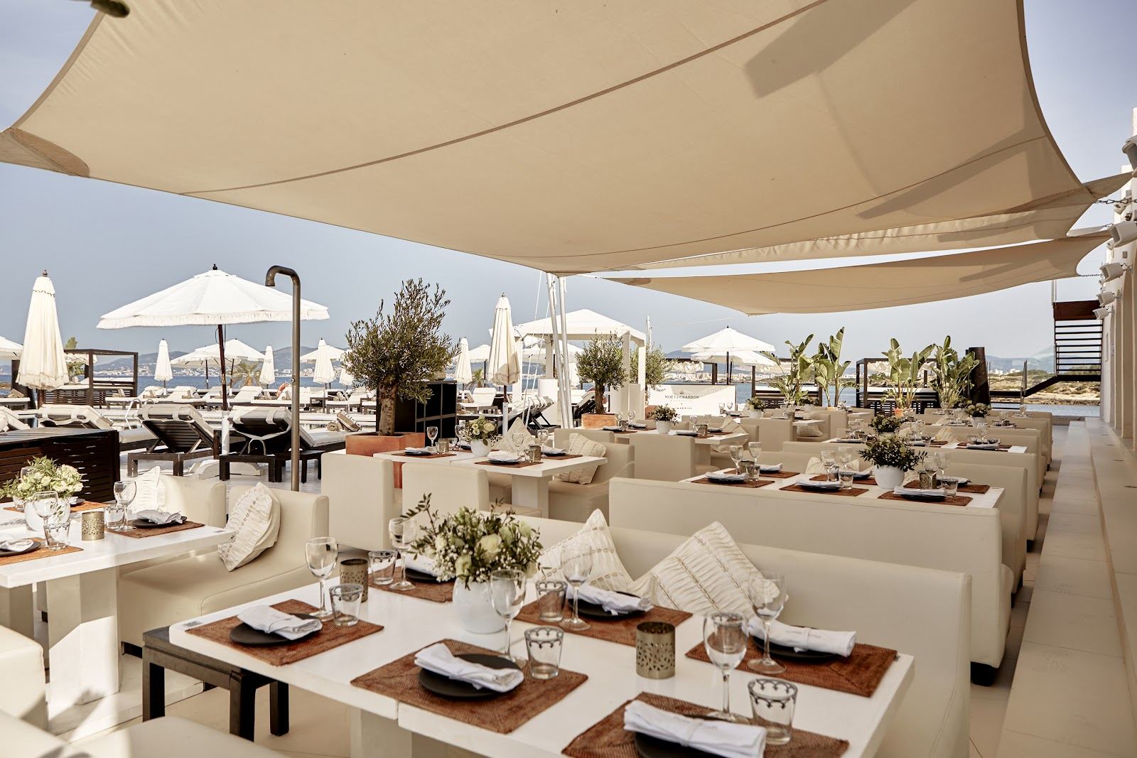 Sunbeds and pool at a chic beach club on the Bay of Palma in Mallorca