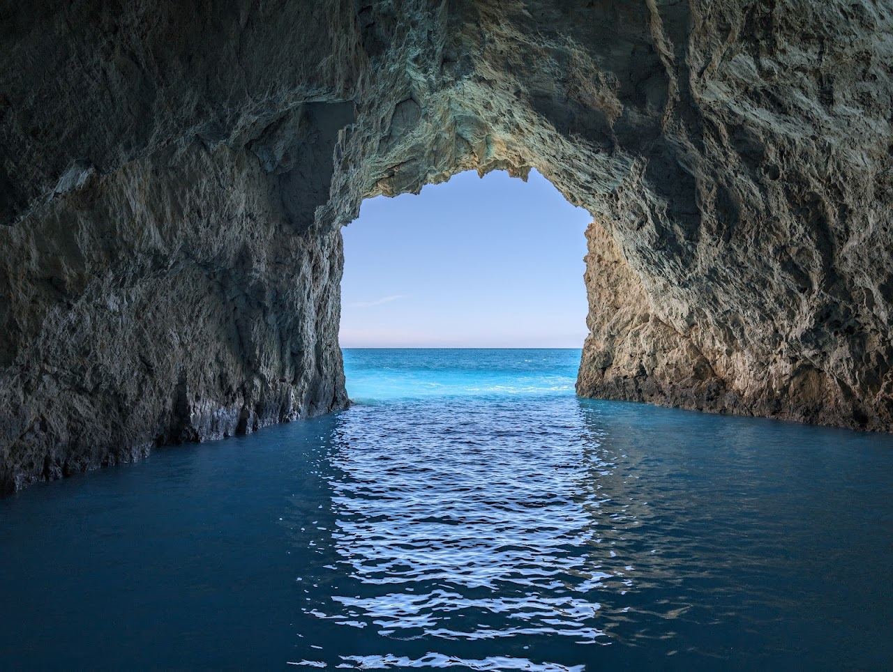 Clear turquoise water and a small sandy cove on the uninhabited islet of Marathonisi in the bay of Zakynthos
