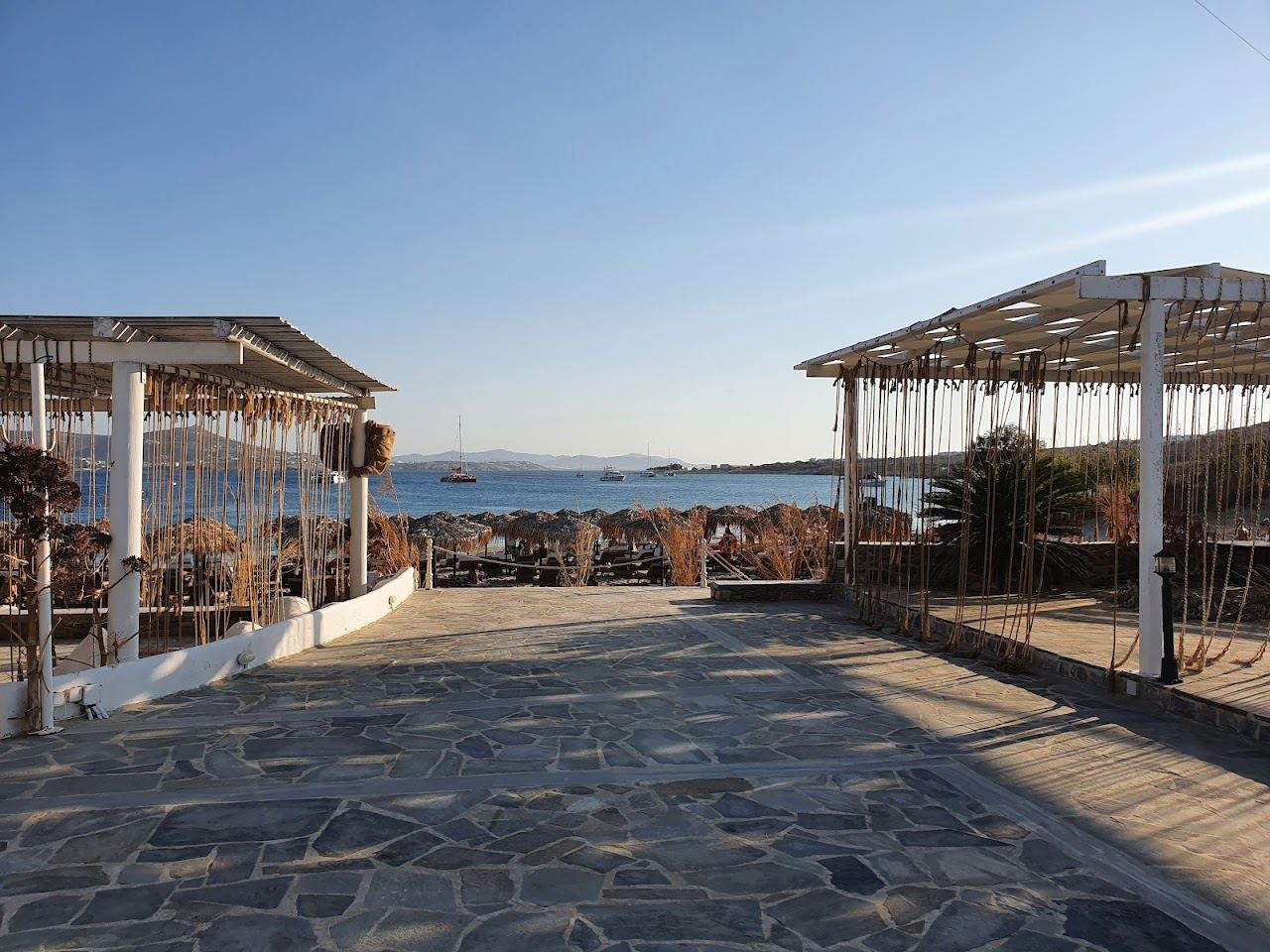 The pale sand and shallow turquoise water of Marcello beach on the north side of Parikia bay on Paros