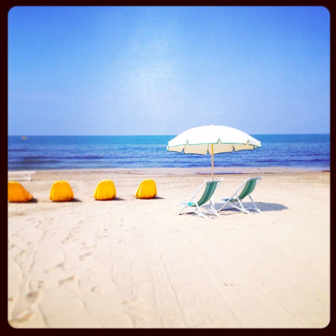 Umbrella rows and pale sand along the Marina di Pietrasanta shore on the Versilia coast