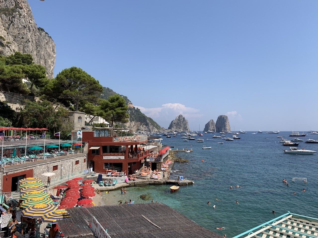 Sun loungers and umbrellas at a lido on Marina Grande beach by the port in Capri
