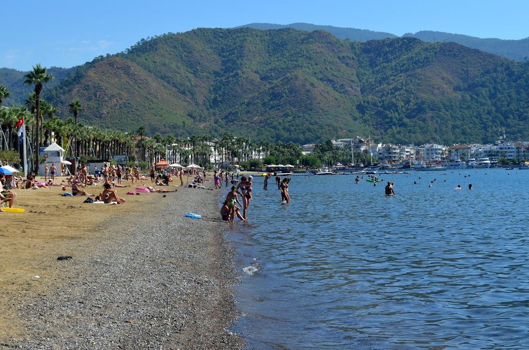 Clear water and pine backed sand on the sheltered bay at Marmaris on the Turkish coast