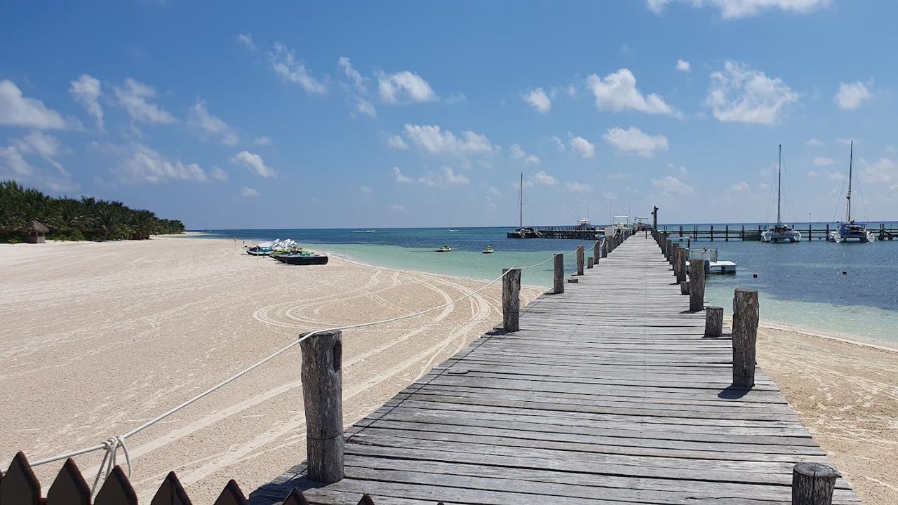 Long powdery white sand and calm clear turquoise water at Playa Maroma in the Riviera Maya