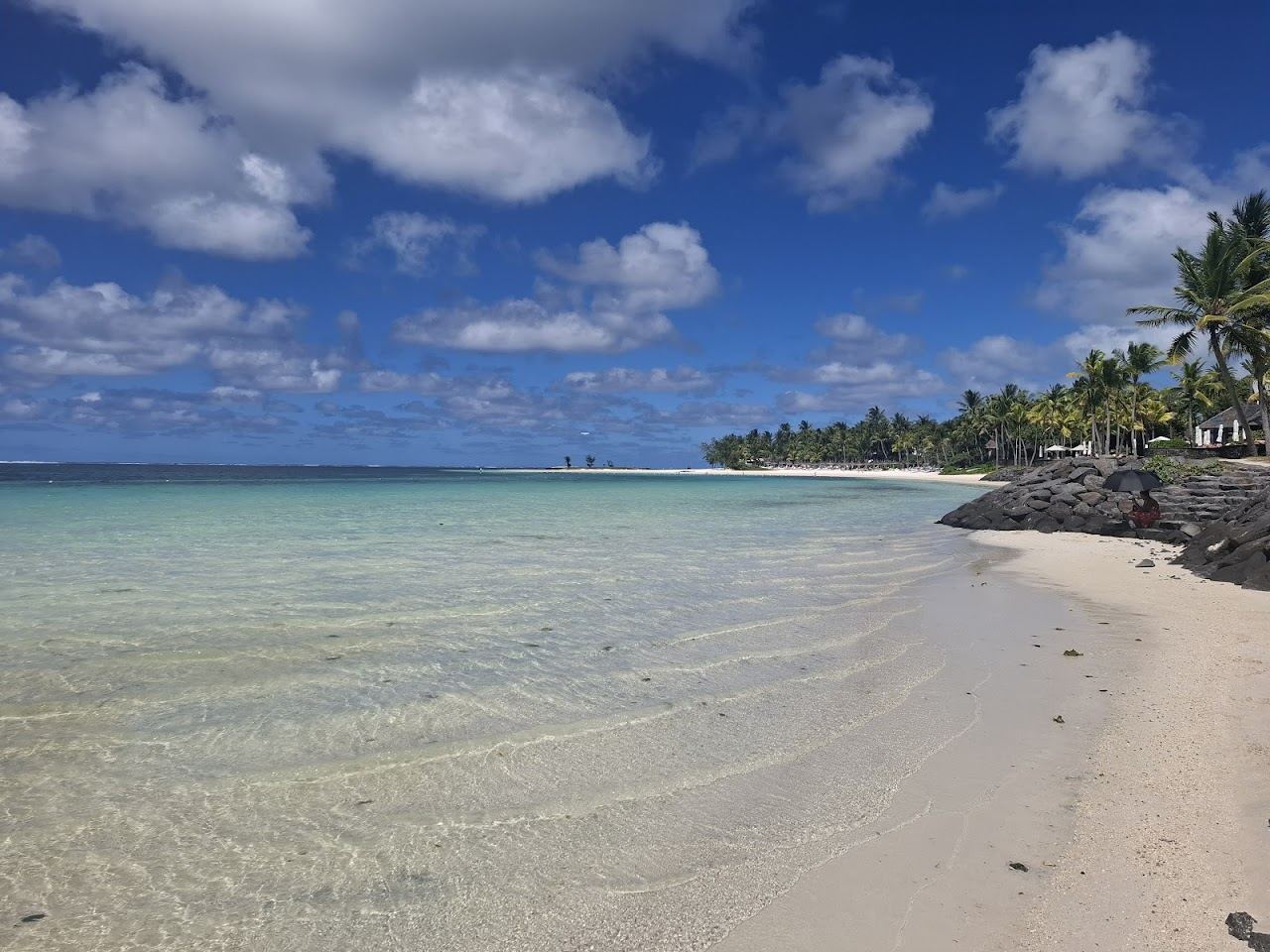White sand and a calm turquoise lagoon backed by casuarina trees at Belle Mare on the east coast of Mauritius