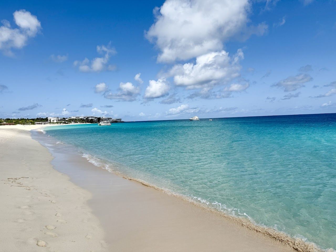 Soft sand and turquoise water backed by low resorts at Meads Bay in Anguilla