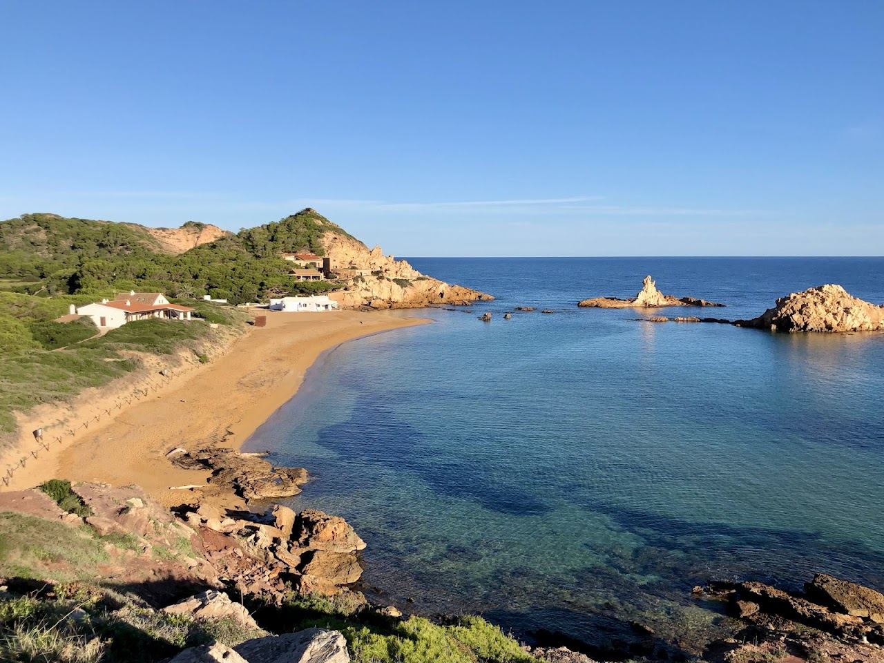 Wild quiet cove with clear water and rock on the coast of Menorca