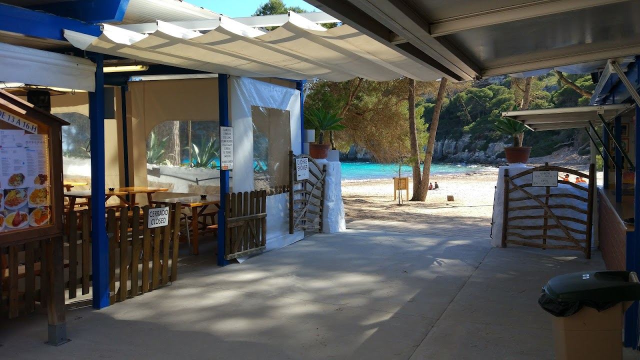 Simple beach bar terrace above the sand at Cala Macarella in Menorca
