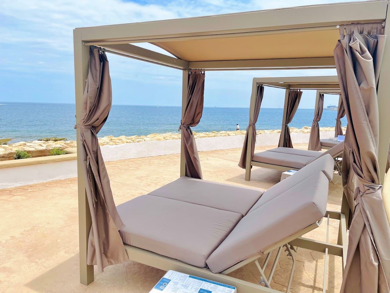 Poolside loungers and sea access at Merkanti Beach Club on the Portomaso waterfront in Malta
