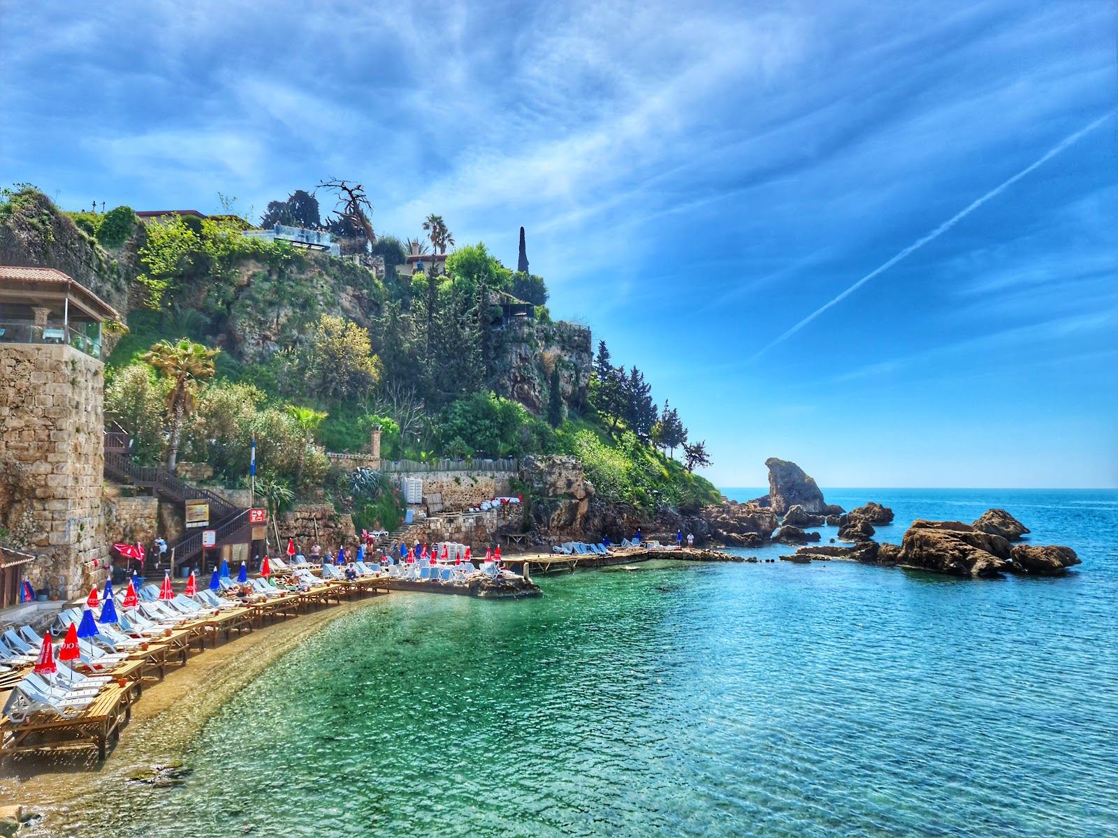 The small sheltered cove of Mermerli beach below the old town cliffs of Kaleici in Antalya