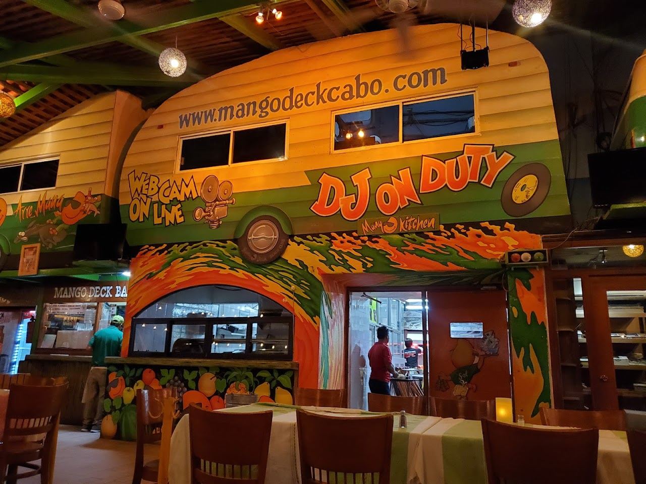 The lively beachfront of Mango Deck on Medano Beach in Cabo