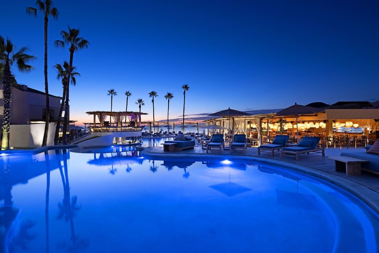 White daybeds and pool at the Nikki Beach club in Cabo San Lucas
