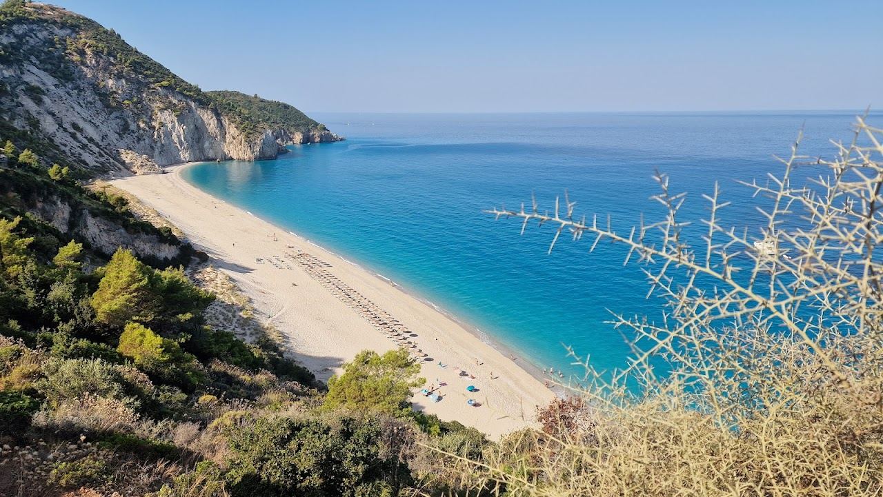 The calm water and sand and pebble shore of Milos beach reached from Agios Nikitas in Lefkada