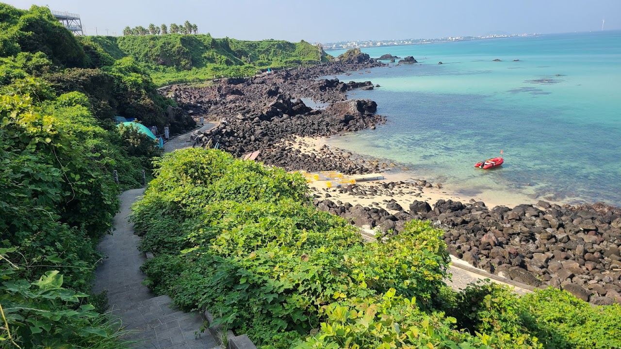 Turquoise water and black volcanic rock along the Handam coastal walk at Aewol in Jeju