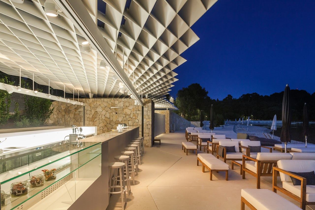 Loungers and parasols at Mulini Beach Bar on the landscaped pebble shore in Rovinj