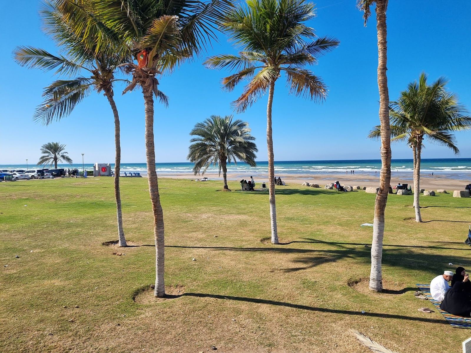 The free public city beach at Qurum in Muscat with soft sand and calm water backed by the corniche