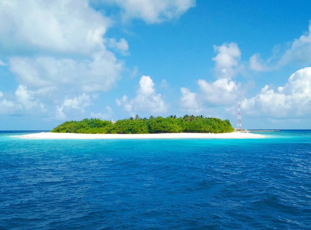 A clean white beach and turquoise lagoon on the eco minded island of Ukulhas