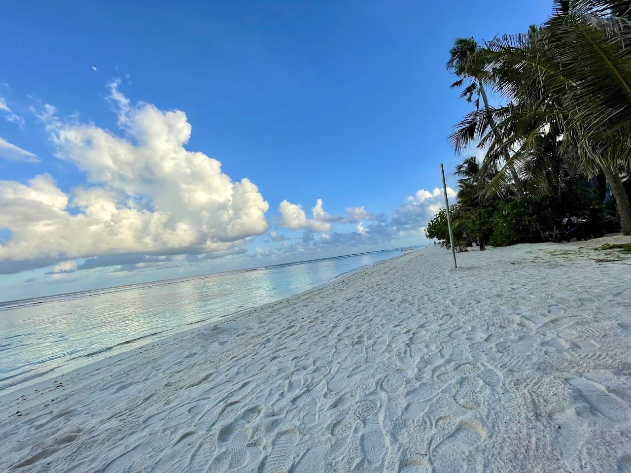 A long man made beach with calm water beside the city of Hulhumale near the airport