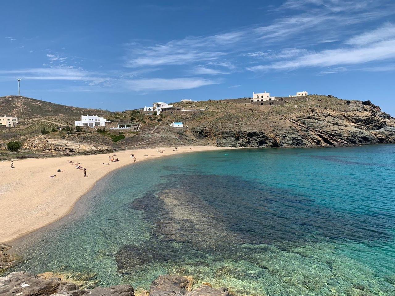 Wild rocky cove and clear water at remote Fokos beach on the north coast of Mykonos