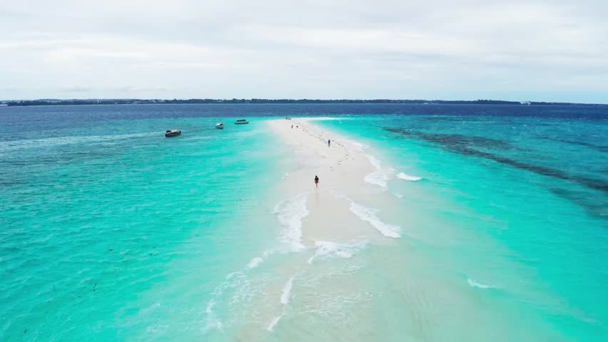 A thin white sandbank ringed by clear shallow turquoise water at Nakupenda in the marine reserve off Stone Town in Zanzibar