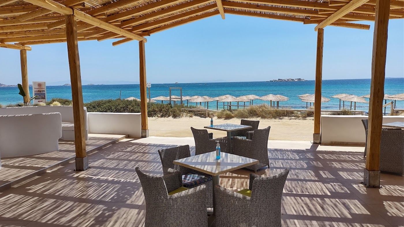 Long white sand and turquoise water at Plaka beach with relaxed beach bars in Naxos