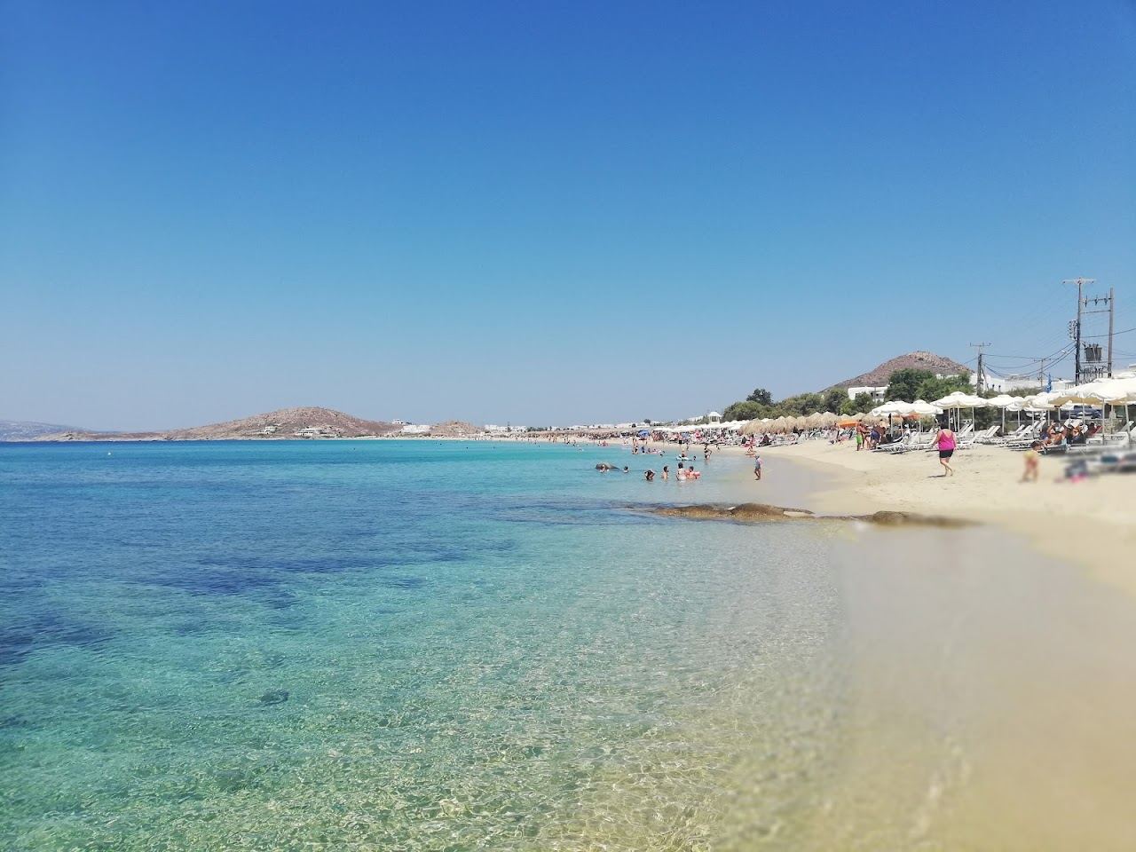 The long golden sand and vivid clear water of Agios Prokopios beach on the southwest coast of Naxos