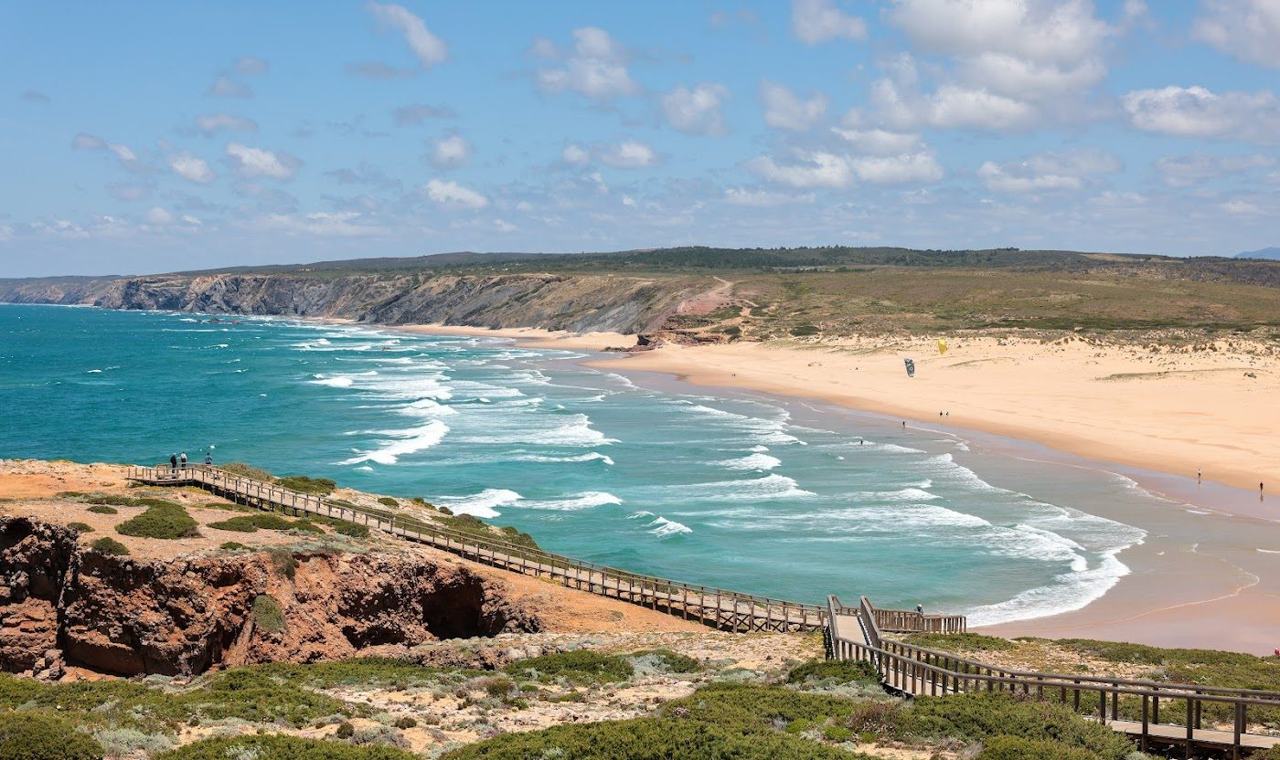 A vast wild beach backed by dunes on the windswept west coast of the Algarve