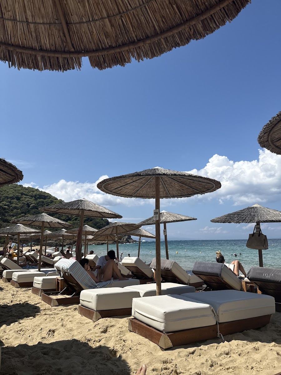 The long crescent of fine pale sand at Big Banana beach on Skiathos seen along the waterline