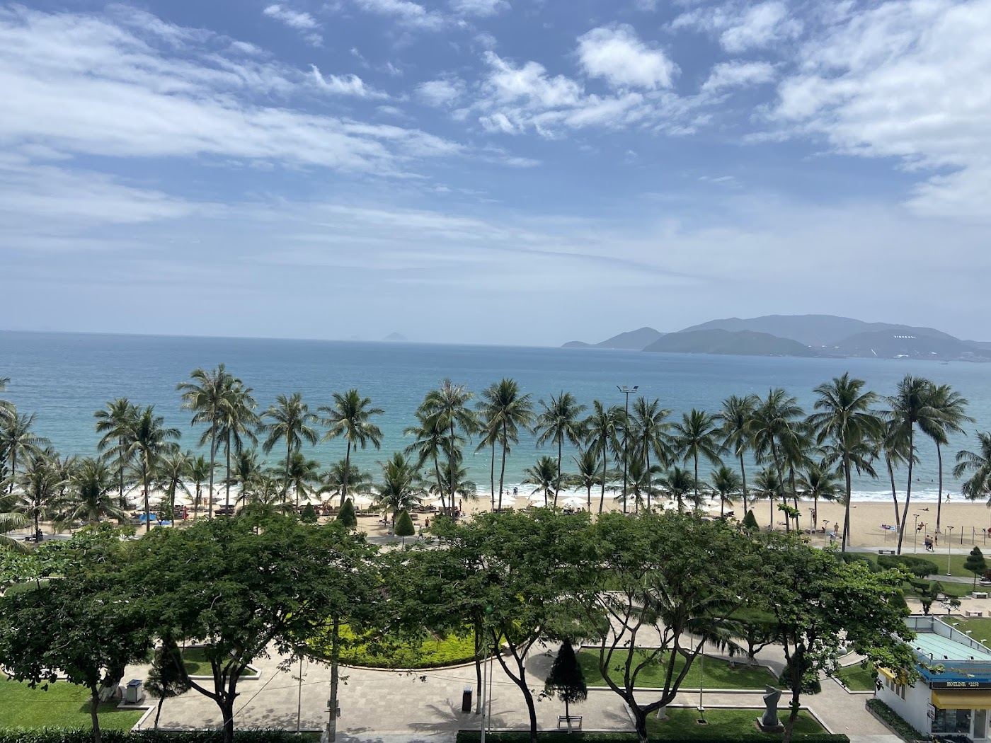 The long curve of Nha Trang bay and its city beach in Vietnam at first light