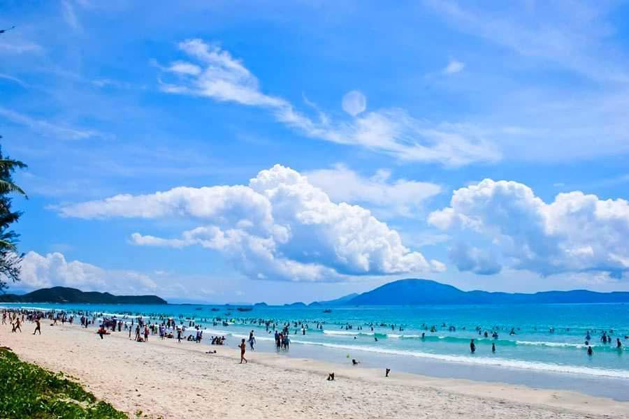 Soft pale white sand and calm clear water at Doc Let beach north of Nha Trang Vietnam