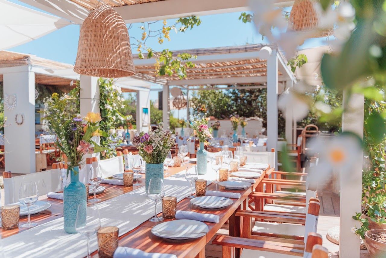 White daybeds and umbrellas of Nikki Beach Costa Smeralda in the cove of Cala Petra Ruja, Sardinia