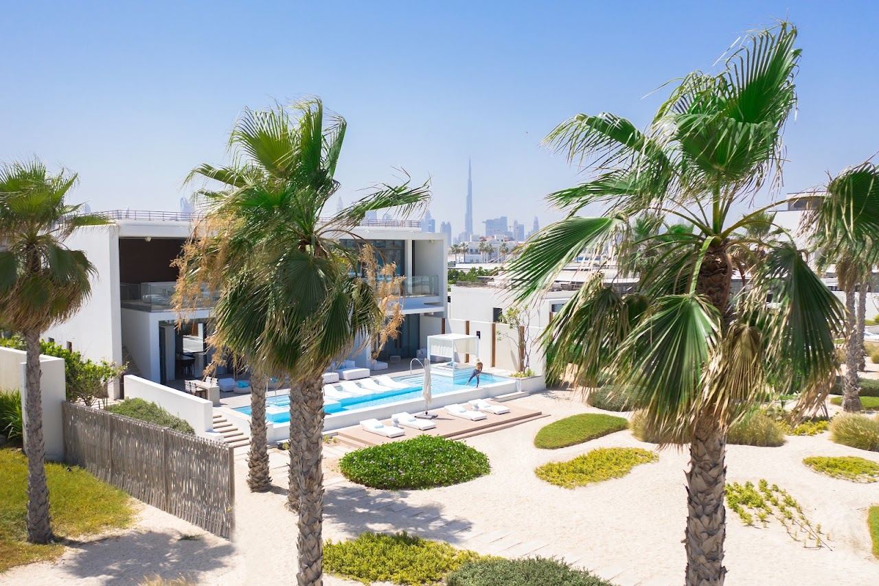 Pool and loungers at sunset at Nikki Beach Resort and Spa Dubai