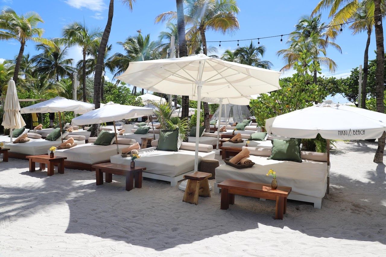 Loungers, palms and beachfront setup at Nikki Beach Miami Beach in South of Fifth