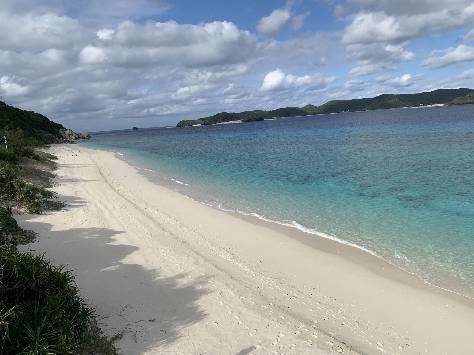 The white coral sand and clear reef water of Nishihama Beach on Aka Island, Okinawa