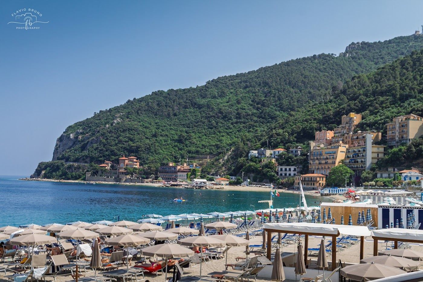 The long sandy beach and medieval town of Noli on the Ligurian coast